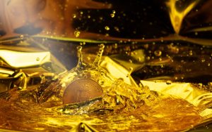 Bitcoin dipping in the gold color water representing the crypto liquidations